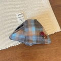 Detail of plaid fabric hair claw clip with vintage buttons on a woven textured mat - Blue