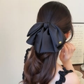 Elegant large black satin bow hair clip with a gold metal tag for an upscale ponytail look - Black