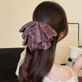 Brown paisley bow hair clip with vintage cashew print shown on a model hair style - Coffee Paisley Print