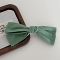 Elegant sage green twill scrunchie with bow detail on a stylish walnut wood tray - Spring Clips / Dark Green