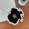 Detailed shot of black velvet scrunchie with white pleated lace trim on wooden table - Black Velvet Scrunchie / Black