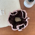 Detailed shot of dark brown velvet scrunchie with pink ruffle edges on a wooden table - Wine Red Velvet Scrunchie / Burgundy