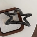 Star-shaped hair claw clip with black marble texture and gold metal spring closure - Silver Star / Black