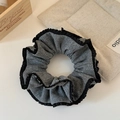 Close-up of grey knit scrunchie with delicate black lace trim on a beige fabric mat - Double Layer Lace Scrunchie (Grey)