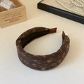 Detail of coffee brown floral headband with vintage felt texture and non-slip inner lining - Brown Floral