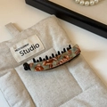 Detailed macro view of the marble texture acetate banana hair clip on a linen display mat - Beige Coffee