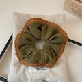 Detailed view of olive green knit scrunchie featuring decorative brown crochet lace trim - Yellow Coffee