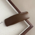Detail of minimalist dark brown leather hair clip with lychee texture for autumn - Faux Leather Coffee