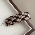 Detailed close-up of brown and beige houndstooth fabric texture on a rectangular hair clip - Coarse Plaid