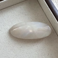 Detailed close-up of oval acetate hair clip with gold France Handmade engraving - Clear White