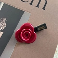 Detailed close-up of a handmade 3D red resin rose hair clip with a gold metal duckbill - Red