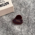 Detail of heart-shaped dark brown acetate hair claw with gold France Handmade logo - Heart Gold Label Mini Claw / Dark Coffee