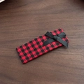 Detail of red houndstooth hair clip with a black ribbon bow on dark wood background - Red Houndstooth - Large Rectangle
