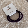 Detail of two dark purple velvet hair scrunchies on a handmade display card - Purple