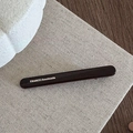 Detailed close-up of dark brown handmade hair clip showing the France Handmade logo - Brown