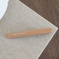 Detailed close-up of matte brown hair clip with golden France Handmade engraving - Apricot