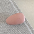 Detail view of oval matte hair clip in dusty pink on soft textured background - Pink