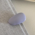 Close-up of matte purple oval hair clip with fine sandy texture on leather background - Purple