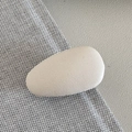 Detail view of the matte beige water-drop hair clip with smooth faux leather texture - Beige