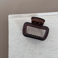 Detail shot of the translucent dark brown acrylic hair claw with minimalist square cutout - Hollow Square Style / Transparent Tea