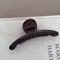Detail view of transparent brown hair claw clip with elegant curved lines and glossy finish - Slender Line Style / Transparent Tea