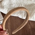 Close-up of straw woven headband with natural fiber texture and beige velvet lining - Brown