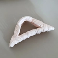 Close-up of the light pink satin fabric texture and elegant pleats on the shark hair clip - Creamy White Triangle Style