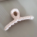 Detail view of pink satin fabric wrapped shark hair clip with soft spiral texture - Milk White Hanger Shape