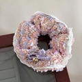 Close-up of pink and purple woven hair tie with lace trim, bow and gold heart charm - Purple Bow Scrunchie