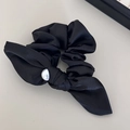 Detail of elegant black satin bow hair clip featuring a centered white pearl accent - Black Satin Pearl Bow Hair Tie