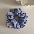 Detail view of the blue striped cotton fabric scrunchie with soft pleats and brand label - Sea Salt Series Striped - Blue