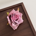 Close-up of Morandi pink silk rose hair clip showing realistic petal textures and green leaves - Pink