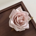 Detailed macro view of a pink fabric rose hair clip on a vintage wooden tray - Light Pink