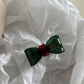 Detail of the handmade green acetate bow hair clip showing the France Handmade text engraving - Dark Green