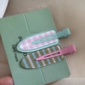 Close-up of pink plaid and striped non-crease hair clips on a handmade card display - Sea Salt Avocado