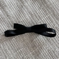Detailed view of the double-layer black satin ribbon bow with smooth glossy texture - Black