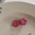 Close-up of pink jelly bow hair tie on a white ceramic plate for cute daily styling - Duckbill Hair Clips / Deep Pink