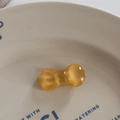Close-up of translucent yellow resin bow hair clip with jelly-like texture and cat-eye luster - Duckbill Hair Clips / Yellow