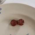 Close-up of translucent amber bow hair tie on a minimalist white ceramic display plate - Duckbill Hair Clips / Dark Coffee