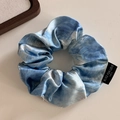 Detailopname van blauwe marmeren zijden scrunchie met Blind for Love label - Olieverf Blauw - Klein