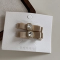 Close-up of champagne satin bow hair clip featuring a large crystal and rhinestone center - Apricot