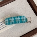 Detailed close-up of blue and green checkered acetate hair clip with silver metal base - Blue Plaid