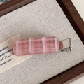 Macro view of pink and white checkered acetate hair clip with silver metal prong - Pink Plaid