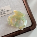 Detail shot of marble textured acetate hair claw clip with Barrette La France lettering - Green