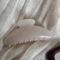 Close-up of cream resin hair claw clip with smooth fan shape on linen fabric - Simple Fan-Shaped / Clear White