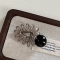 Detail shot of a dark grey spiral hair tie with a black polished bead on a neutral background - Telephone Line - Black Ball / Black