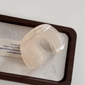 Detailed view of a translucent cream hair claw clip with a sleek organic curved design - Translucent Beige Claw - N-Shape