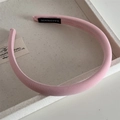 Detail of pink fabric headband featuring ribbed texture and handmade label inside - Solid Pink