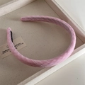 Detailed macro view of a pink fabric padded headband featuring subtle woven textures - Pink Gingham