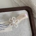 Macro detail of French handmade acetate flower hair clip with pearls on wooden jewelry tray - Pearl Flower Wave Shape - Milky White